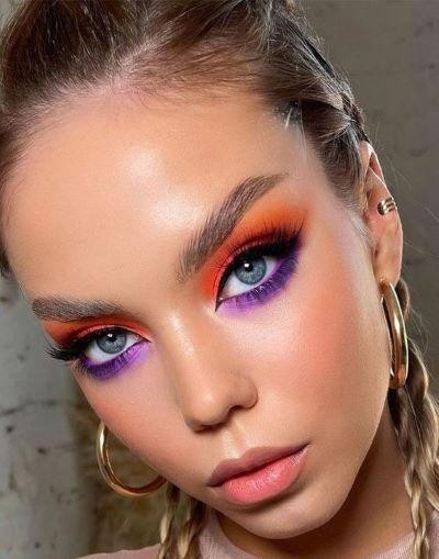 A person with purple and orange makeup

Description automatically generated