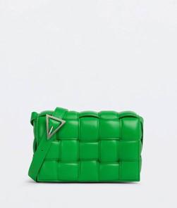 A green bag with a buckle

Description automatically generated