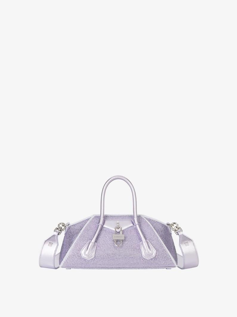 A purple bag with silver handles

Description automatically generated