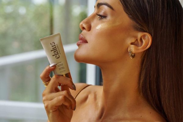 Camila Coelho holds the Elaluz Sun Riser Illuminating Primer (Courtesy of Camila Coelho)