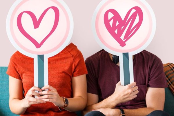happy-couple-holding-heart-signs_53876-42602