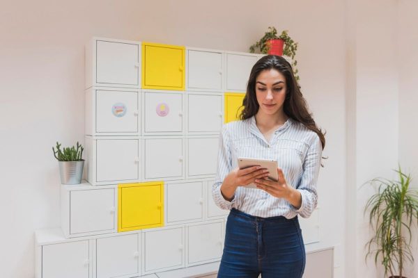 young-businesswoman-working-with-her-tablet-office_23-2147604992